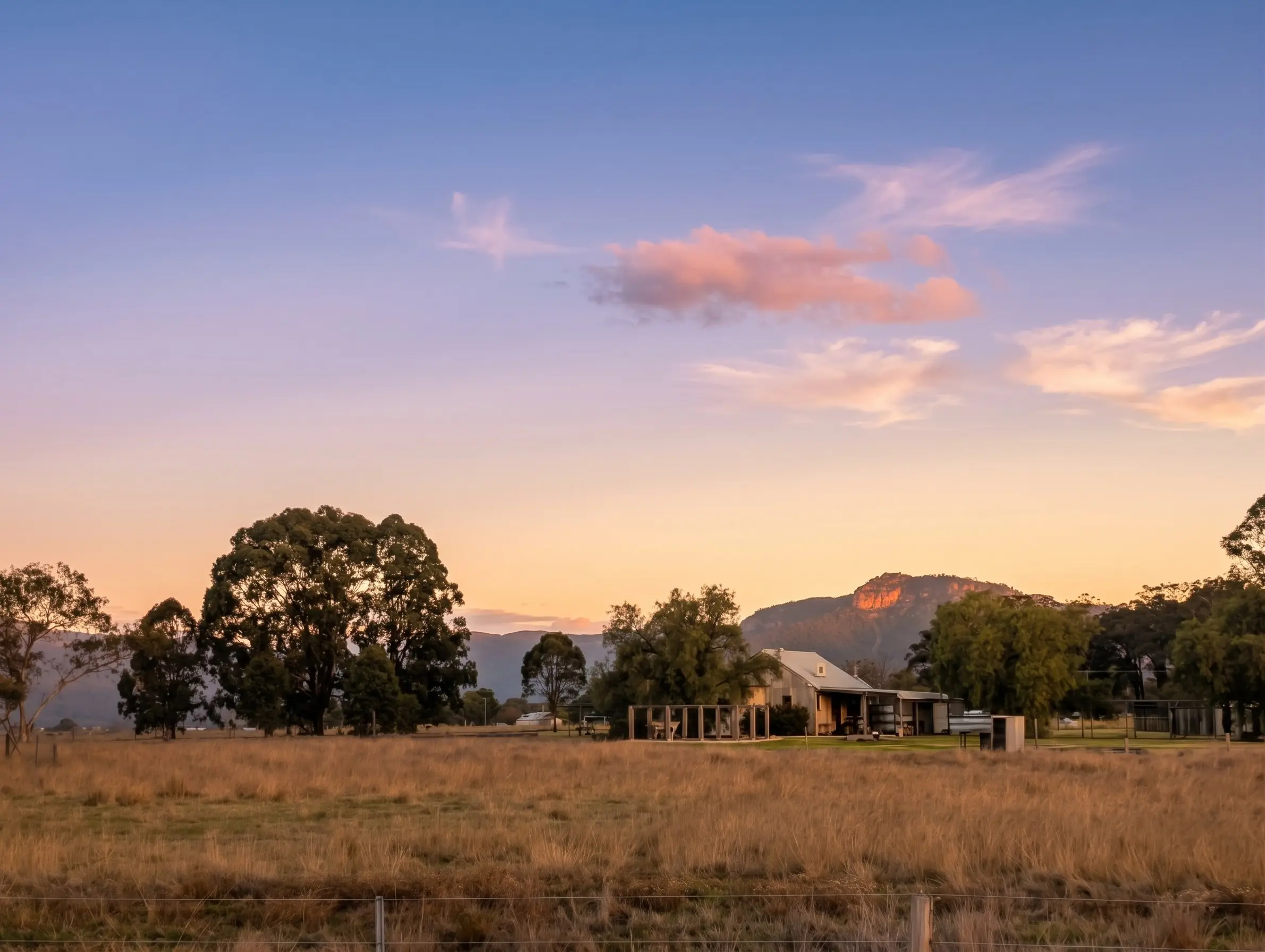 Sunset over the paddocks at Broke Estate, with Yellow Rock lit on the horizon, Broke, Hunter Valley